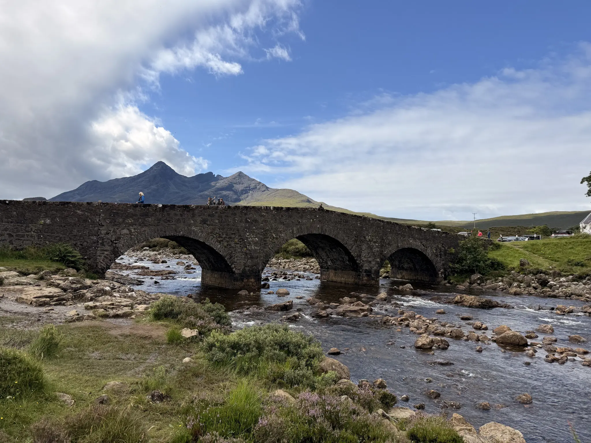 fairy pools bridge with mountains in the background