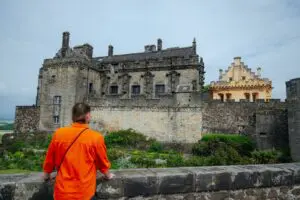 person in orange shirt looking at Stirling Castle, Scotland