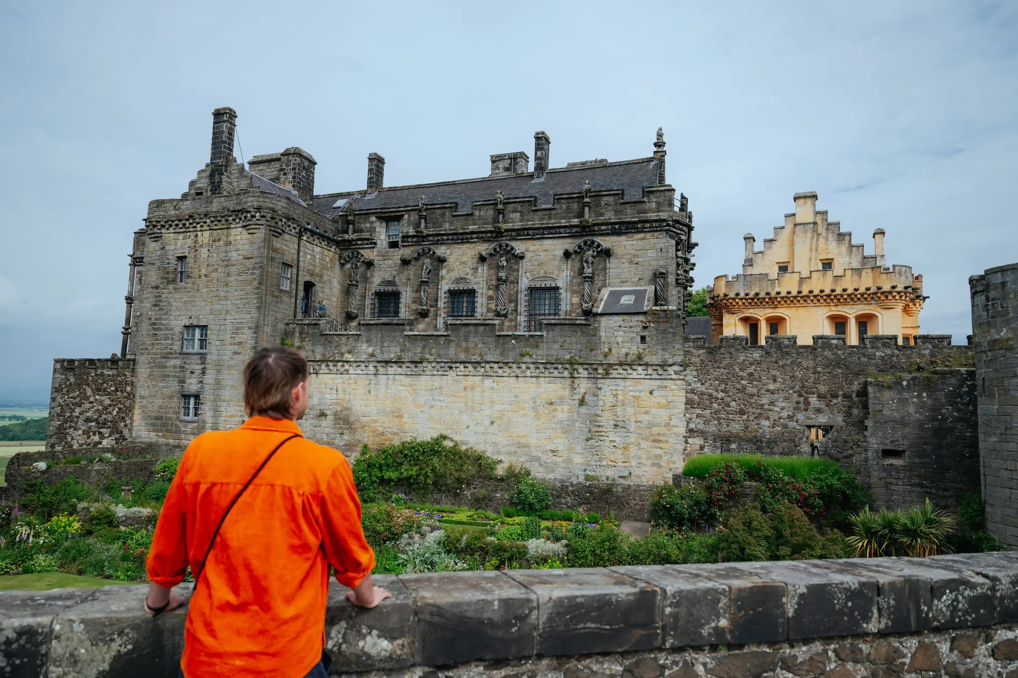 person in orange shirt looking at Stirling Castle, Scotland